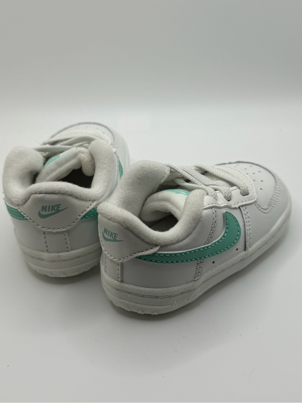 Nike Kids White Sneakers with Teal Swoosh
